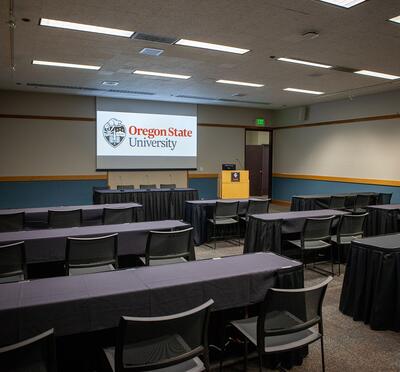 Room set classroom style looking towards the lectern