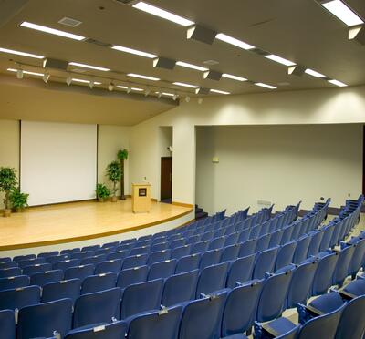 View of Construction and Engineering Hall from back of room looking toward stage